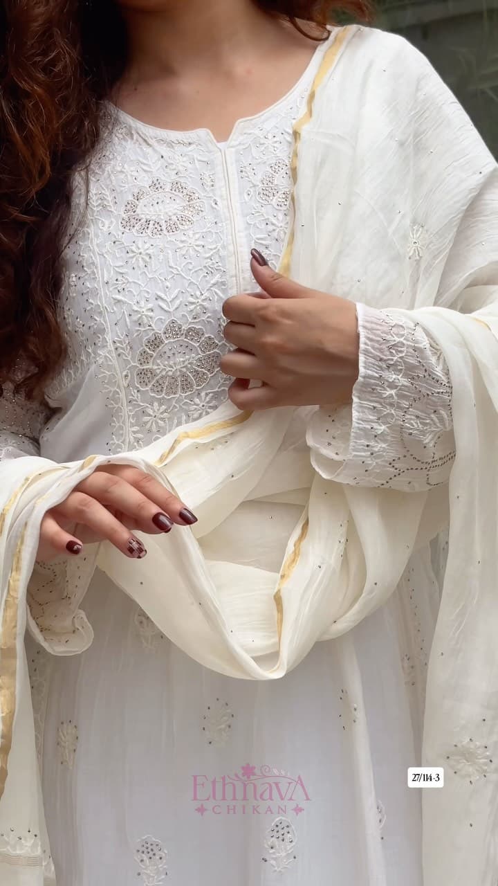 Pure Mul Chanderi, adorned with intricate handwork Chikankari and delicate Mukaish work, comes together in th…